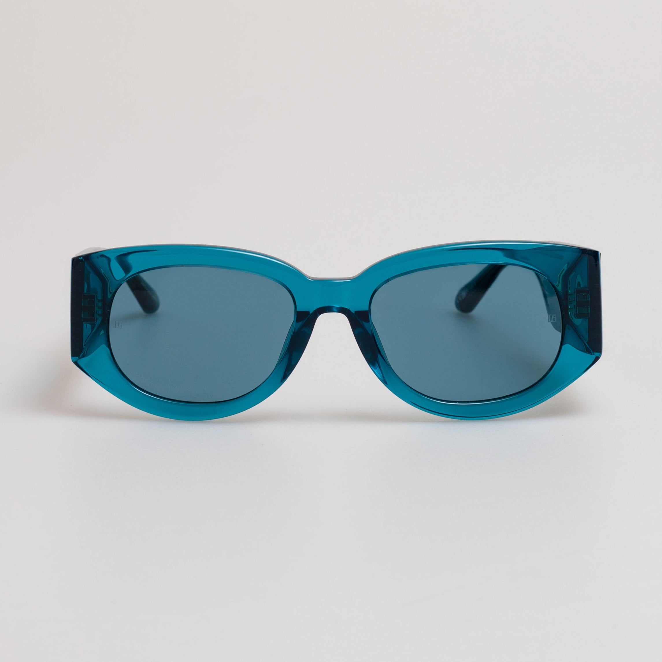 A pair of blue-framed sunglasses with blue lenses, from the LINDA FARROW collection.